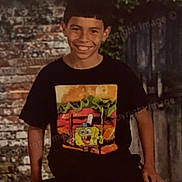 Julian joined the competition — help win amazing prizes! boy, child, smiling, tshirt, spongebob, brick_wall, outdoor, greenery, casual, portrait, young, person, short_hair, sitting, happy, background, year, 2026, clothing, leaves