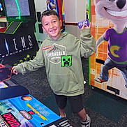 Jesse joined the competition — help win amazing prizes! arcade, boy, carpet, cartoon_character, child, colorful, entertainment, fun, game, gaming_machine, happy, hoodie, indoor, minecraft, mouse, person, shorts, smile, sneakers, ticket