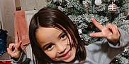Vanessa joined the competition — help win amazing prizes! casual_clothing, child, christmas_tree, decorations, festive, fun, girl, happy, holiday, holiday_spirit, home, indoors, long_hair, my_little_pony, ornaments, peace_sign, person, smile, sweater, wooden_floor