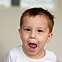 child, boy, face, expression, mouth_open, brown_eyes, short_hair, indoor, portrait, white_shirt, casual, young, curious, cute, skin, person, head, human, childhood, emotional