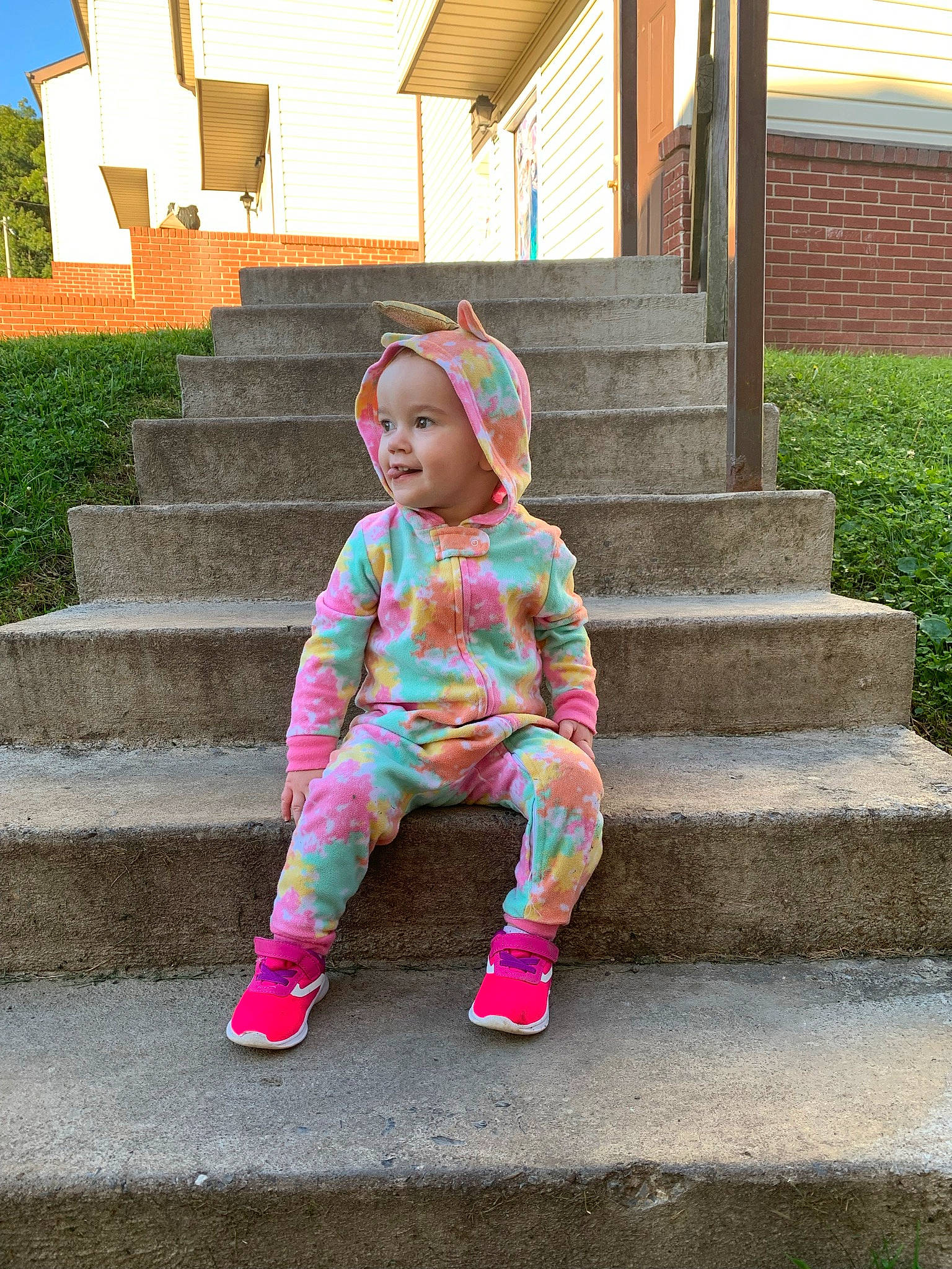 Aurora joined the competition — help win amazing prizes! baby_toddler_clothing, brick, flooring, fun, grass, headwear, joy, leisure, magenta, outerwear, person, pink, plant, sitting, sleeve, smile, stairs, standing, street_fashion, toddler