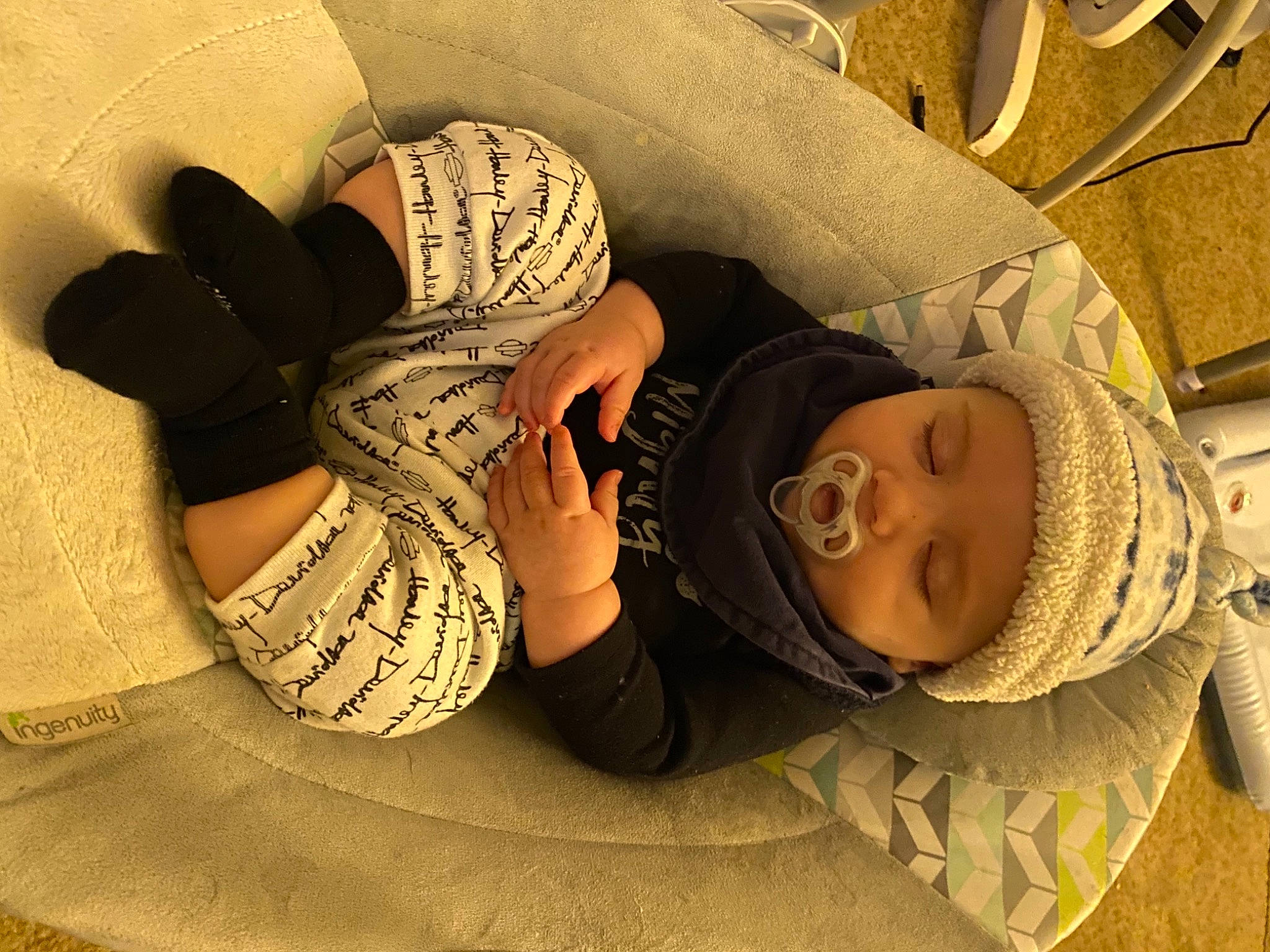 Corbin is registered to the contest to win money with this photo: arm, comfort, cool, fashion_accessory, finger, floor, flooring, foot, hat, headgear, headwear, human_leg, knee, leg, linens, pattern, person, shoe, sitting, sneakers