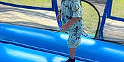 Aziel is registered to the contest to win money with this photo: child, toddler, boy, smiling, inflatable, trampoline, outdoor, play, blue, clothing, mickey_mouse, socks, grass, daylight, fun, joy, happy, shorts, shirt, park
