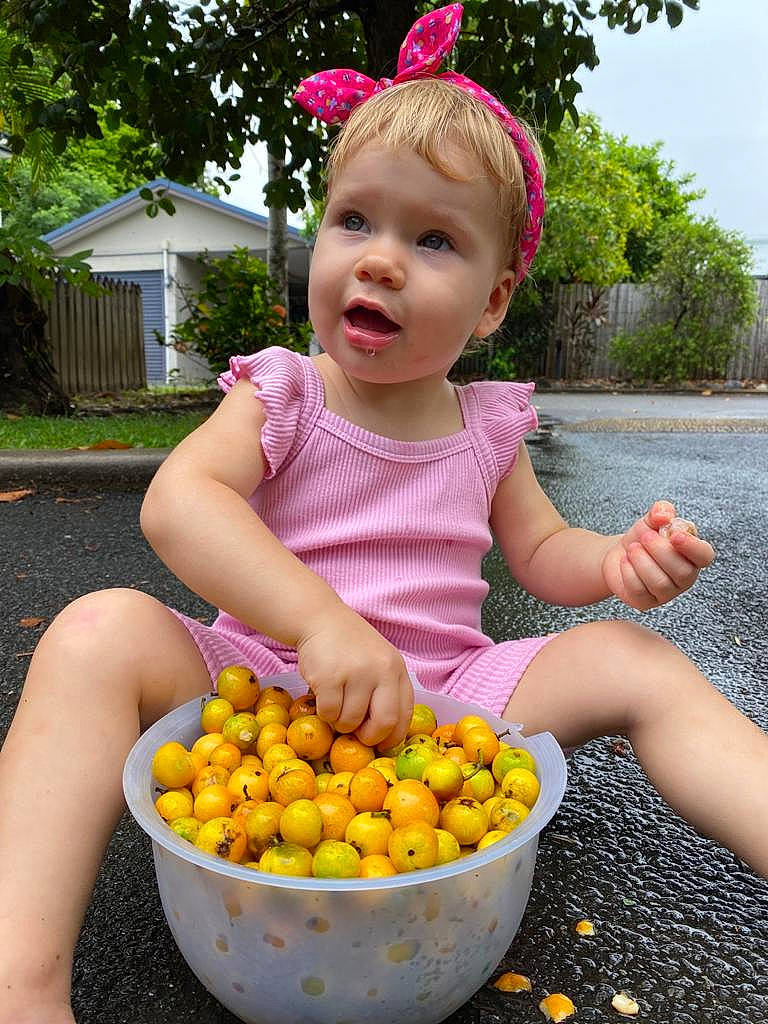Alicia joined the competition — help win amazing prizes! baby_toddler_clothing, bowl, child, citrus, food, fruit, grass, happy, ingredient, legume_family, local_food, natural_foods, person, pink, plant, produce, rangpur, summer, toddler, tree