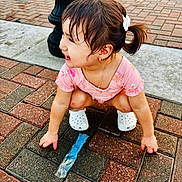 Mailyna joined the competition — help win amazing prizes! toddler, child, girl, wet_hair, ponytail, pink_clothing, white_bow, white_crocs, jewelry, bracelet, pavement, brick_floor, lamp_post, outdoor, smiling, crouching, playful, summer, popsicle_wrapper, happy