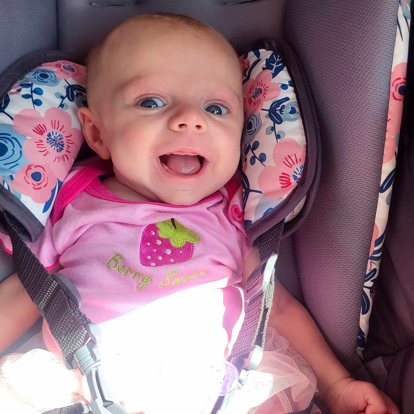 Brooke is registered to the contest to win money with this photo: accessories, baby, babylaughing, car, car_interior, clothing, cushion, face, happy, head, homedecor, laughing, person, photography, portrait, strap, stroller, t_shirt, transportation, vehicle