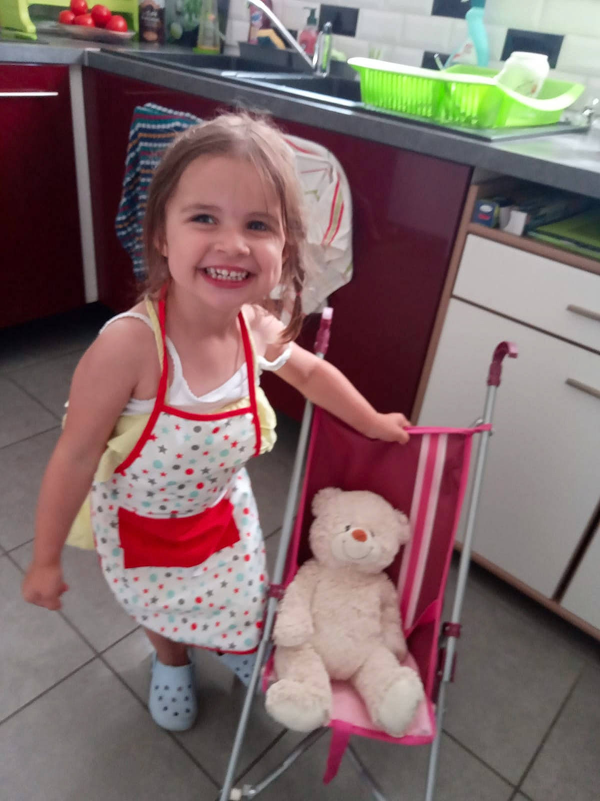 Zélia participe au concours pour gagner de l'argent avec cette photo : baby_toddler_clothing, child, floor, flooring, fun, happy, head, home_appliance, human_leg, joy, kitchen_appliance, pattern, person, room, skin, smile, snapshot, sock, standing, toddler