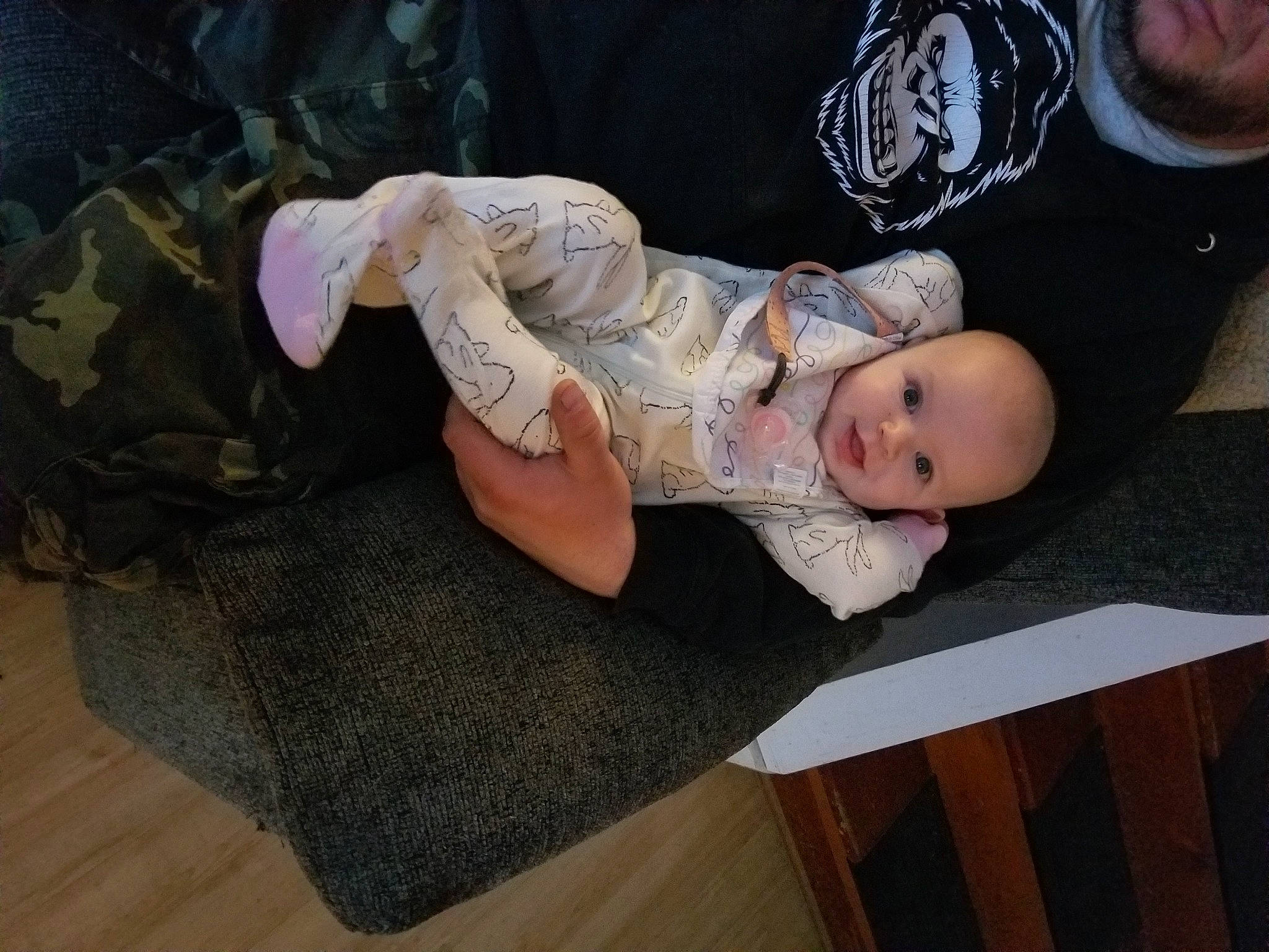 Ruth is registered to the contest to win money with this photo: baby, baby_products, baby_toddler_clothing, child, dress, event, fashion_accessory, grass, happy, hat, headpiece, jewellery, lap, leg, person, plant, sitting, sleeve, toddler, tree