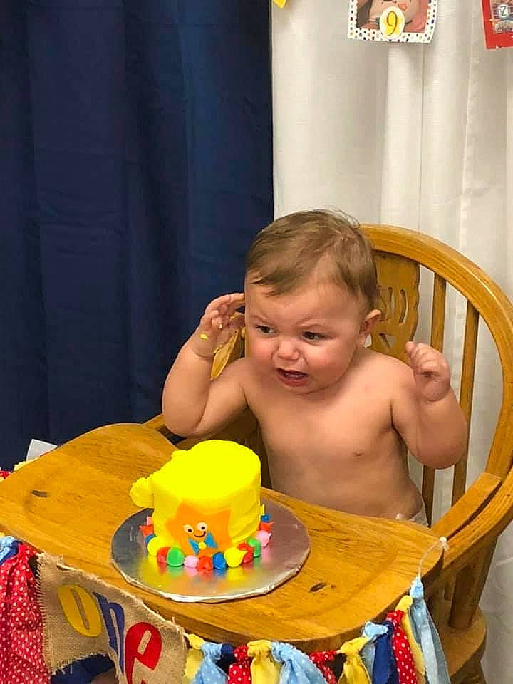 Aniah joined the competition — help win amazing prizes! baby, baked_goods, bathing, birthday_cake, cake, cake_decorating, chair, child, event, food, fun, furniture, icing, leisure, person, plate, sharing, sweetness, table, tableware