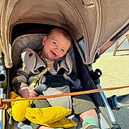 Timao a rejoint le concours — aidez-le/la à gagner de superbes lots ! baby, child, stroller, smiling, plush_toy, harness, sunlight, blue_eyes, clothing, socks, footwear, seat, canopy, happy, infant, outdoor, cute, comfort, portrait, person
