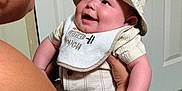 Michael joined the competition — help win amazing prizes! baby, smiling, hat, bib, woman, glasses, earrings, holding, indoor, door, hanger, carpet, arm, clothing, person, portrait, cute, happy, infant, child