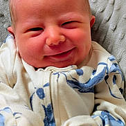 Michael joined the competition — help win amazing prizes! baby, smile, face, infant, clothing, blanket, closeup, cute, child, sleepwear, soft, happy, young, portrait, comfort, warm, expression, newborn, person, cozy