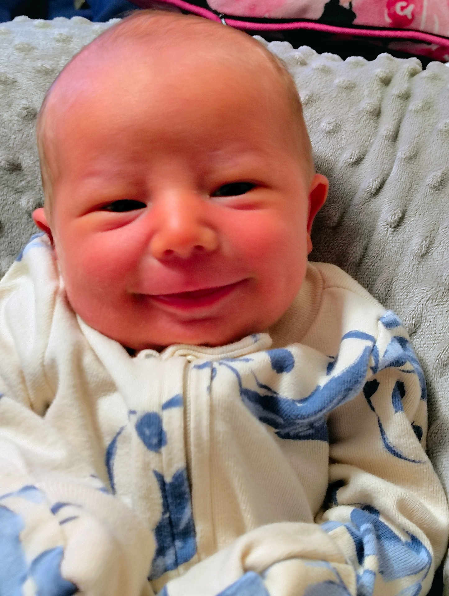 Michael joined the competition — help win amazing prizes! baby, smiling, infant, closeup, face, clothing, blanket, soft_texture, blue, white, pink_background, happy, cute, young_child, portrait, indoors, person, cozy, newborn, sleepwear