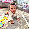 Ellieonna joined the competition — help win amazing prizes! baby, child, crawling, smiling, curly_hair, carpet, toy, colorful, pink, indoor, playful, happy, infant, person, home, sleeve, furniture, blurred_background, floor, cute