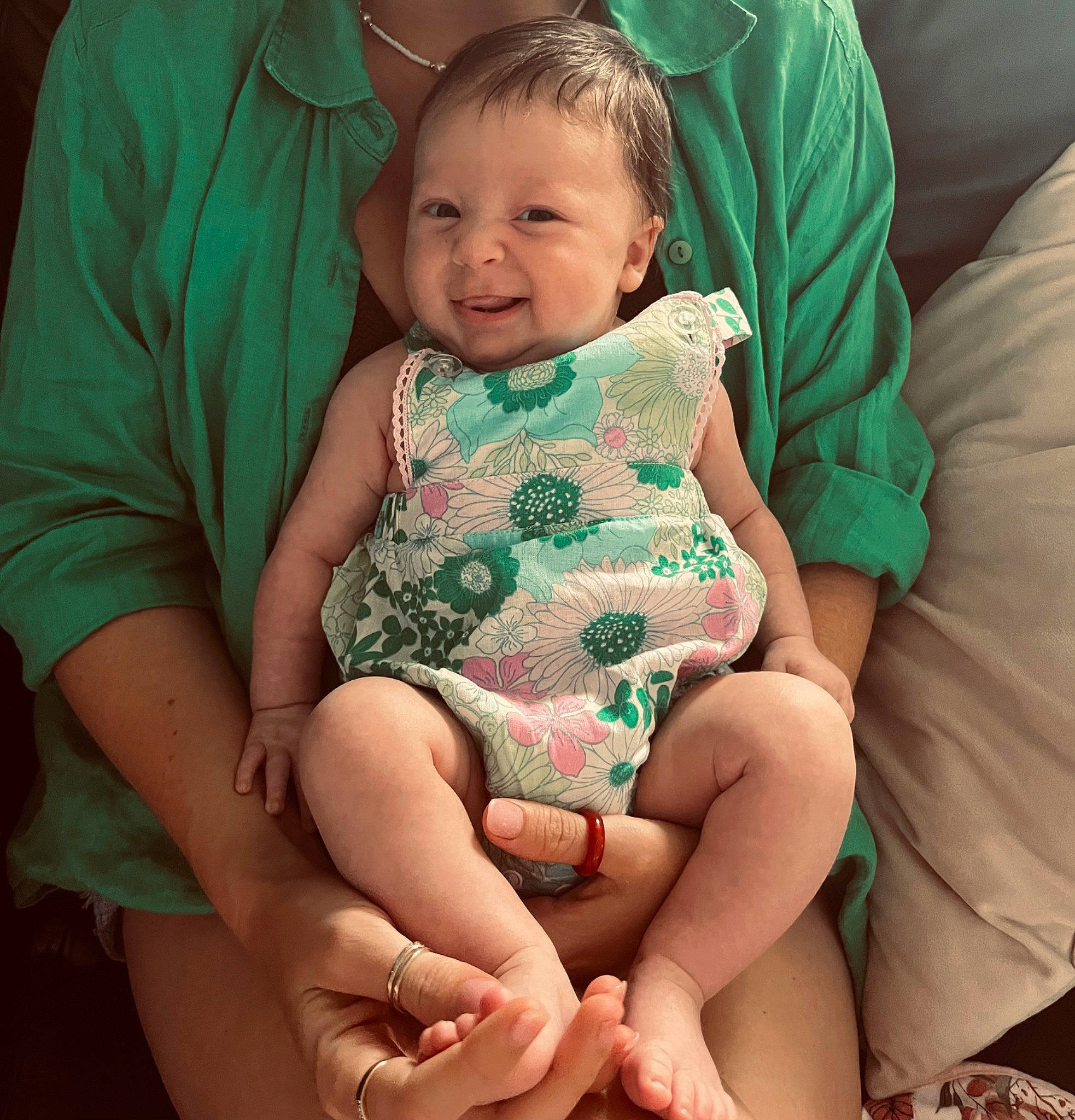 Indiana is registered to the contest to win money with this photo: arm, baby, baby_toddler_clothing, cheek, child, comfort, eye, face, finger, gesture, hand, happy, iris, lap, person, pink, skin, sleeve, smile, thigh