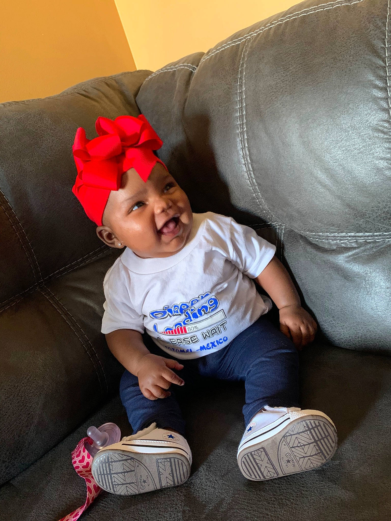 Janiya is registered to the contest to win money with this photo: baby, child, footwear, fun, happy, leg, person, pink, play, red, shoe, sitting, smile, toddler