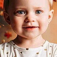 Hayzlee is registered to the contest to win money with this photo: toddler, child, portrait, face, blue_eyes, smile, white_shirt, gold_polka_dots, short_hair, indoor, warm_lighting, autumn, blurred_background, cute, happy, young_child, closeup, person, head_and_shoulders, fashion