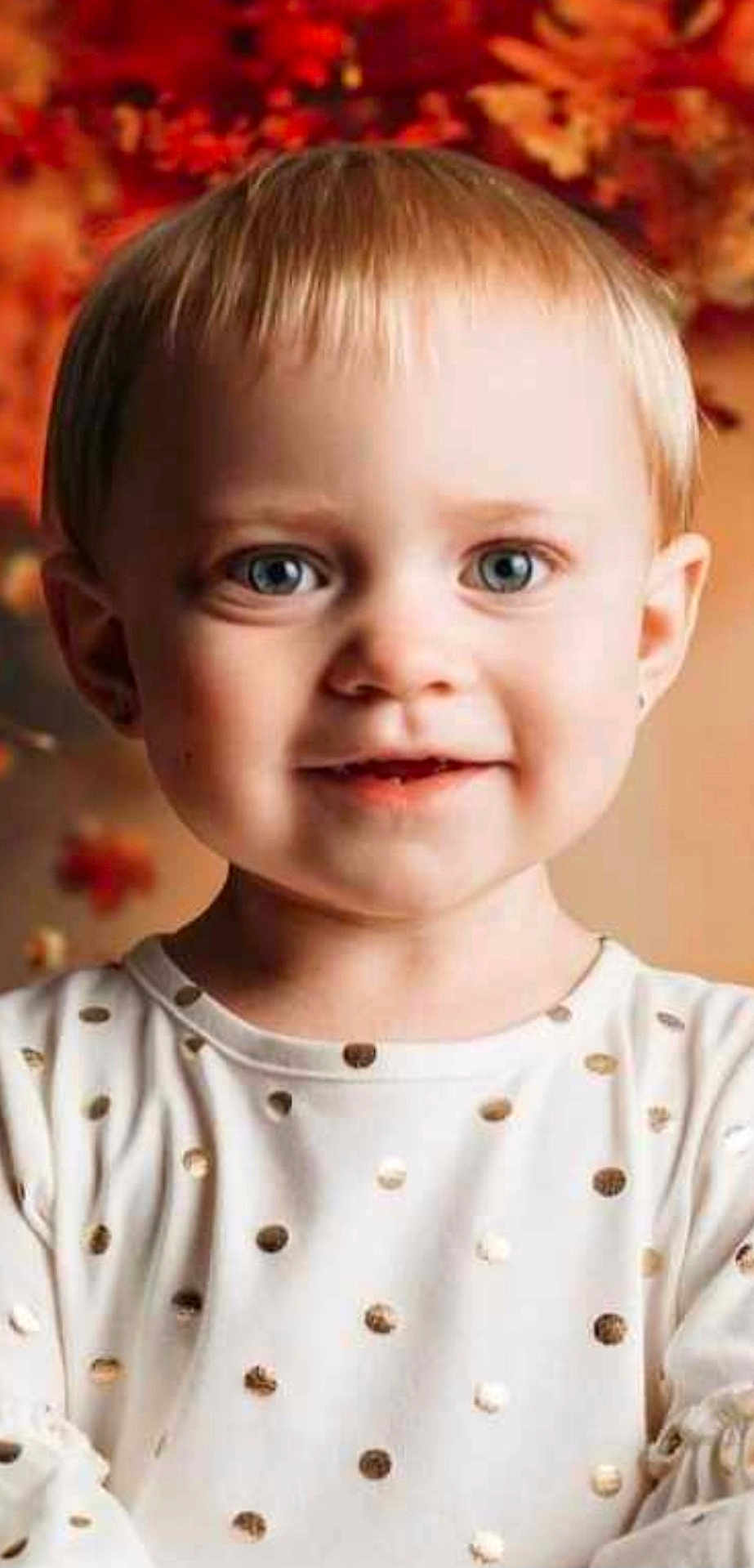 Hayzlee is registered to the contest to win money with this photo: toddler, child, portrait, face, blue_eyes, smile, white_shirt, gold_polka_dots, short_hair, indoor, warm_lighting, autumn, blurred_background, cute, happy, young_child, closeup, person, head_and_shoulders, fashion