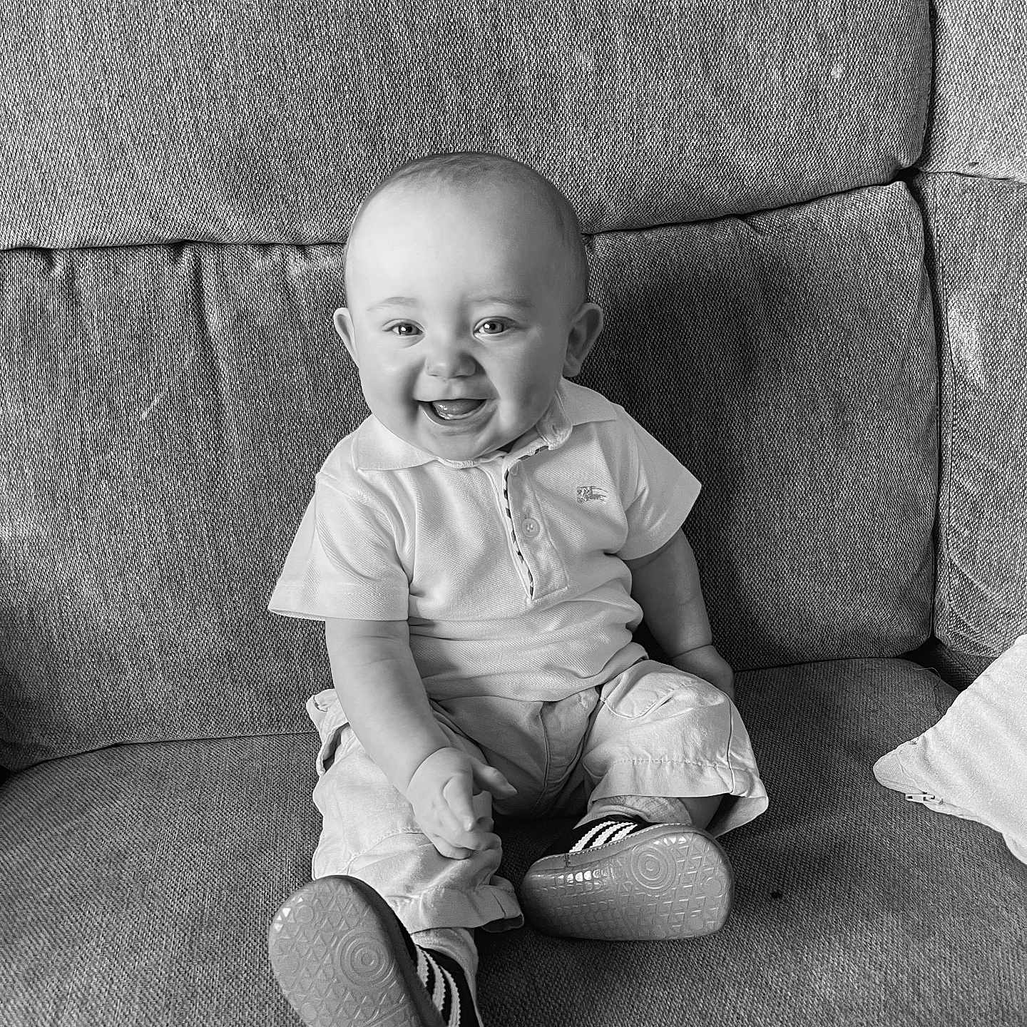 Clay joined the competition — help win amazing prizes! baby, black_and_white, child, clothing, couch, cute, face, happy, home, indoor, pants, person, polo_shirt, portrait, seated, shoes, smile, socks, texture, young_child