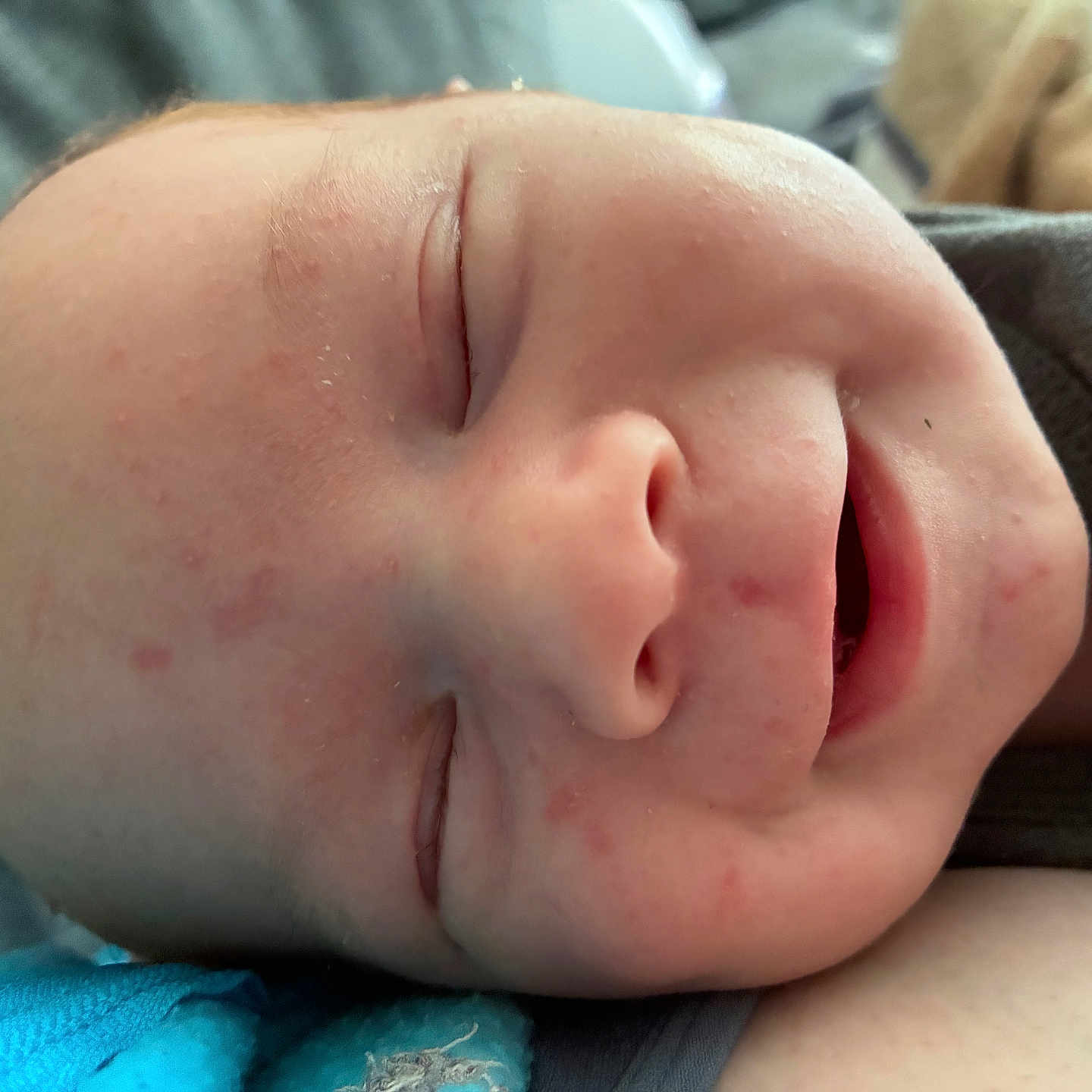 Sutton is registered to the contest to win money with this photo: baby, sleeping, close_up, face, infant, peaceful, smile, skin, rest, soft, cozy, child, portrait, newborn, relaxation, expression, head, person, indoors, comfort