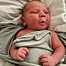 Sutton joined the competition — help win amazing prizes! baby, infant, blanket, bed, bedding, face, expression, pucker, skin, hand, newborn, cute, sleepy, wrapped, soft, cozy, child, person, portrait, indoors