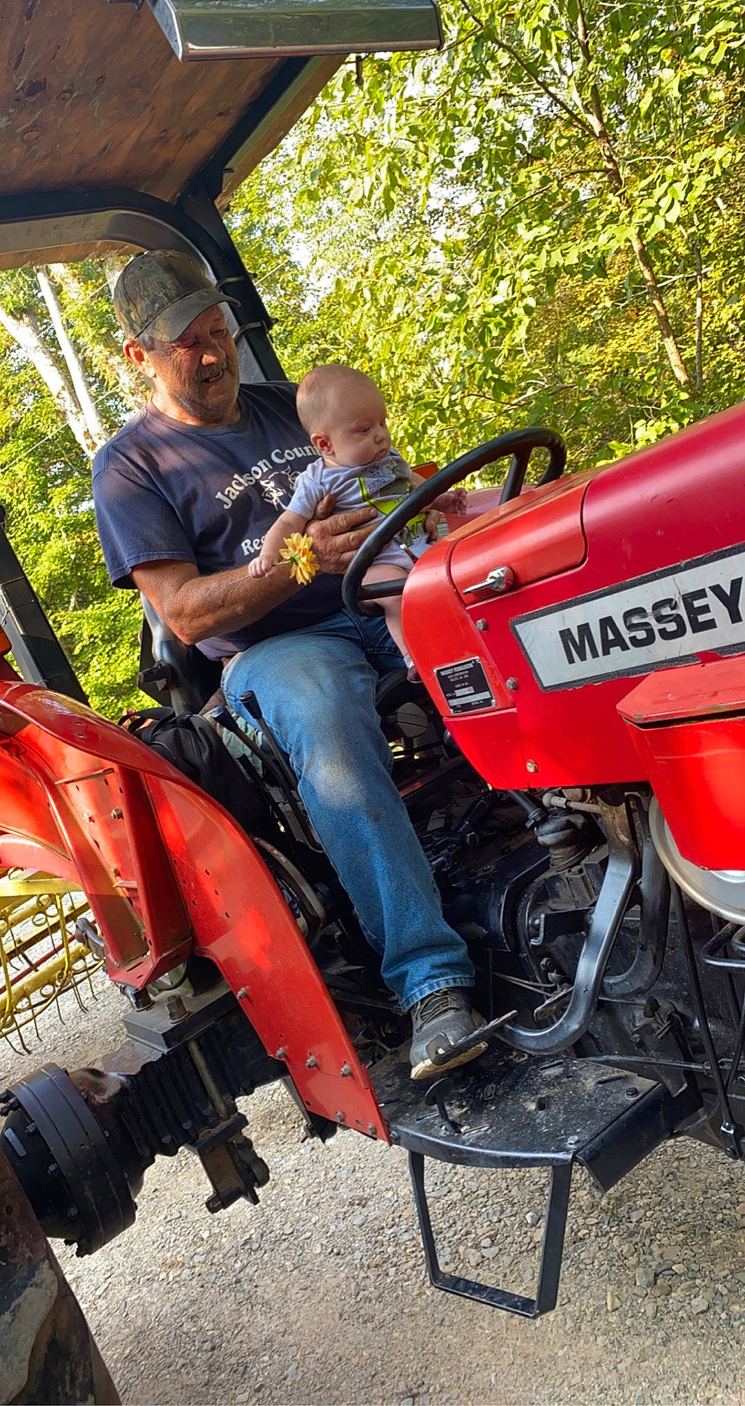 Briar is registered to the contest to win money with this photo: asphalt, auto_part, automotive_design, automotive_exterior, automotive_lighting, automotive_tire, automotive_wheel_system, fender, fuel_tank, grass, headwear, jeans, mode_of_transport, motor_vehicle, motorcycle, person, plant, rolling, tire, tree