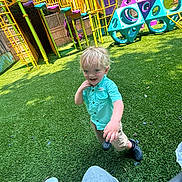Jack joined the competition — help win amazing prizes! child, toddler, playground, climbing_structure, yellow, purple, blue, green, grass, outdoor, happy, smiling, shorts, shirt, footwear, play, daylight, fence, person, reaching