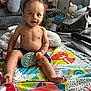 Kobie is registered to the contest to win money with this photo: baby, baby_gear, blanket, child, clothing, colorful, cushion, floor, foot, hand, happy, head, indoor, infant, living_room, person, play_mat, seven_months, smiling, toy