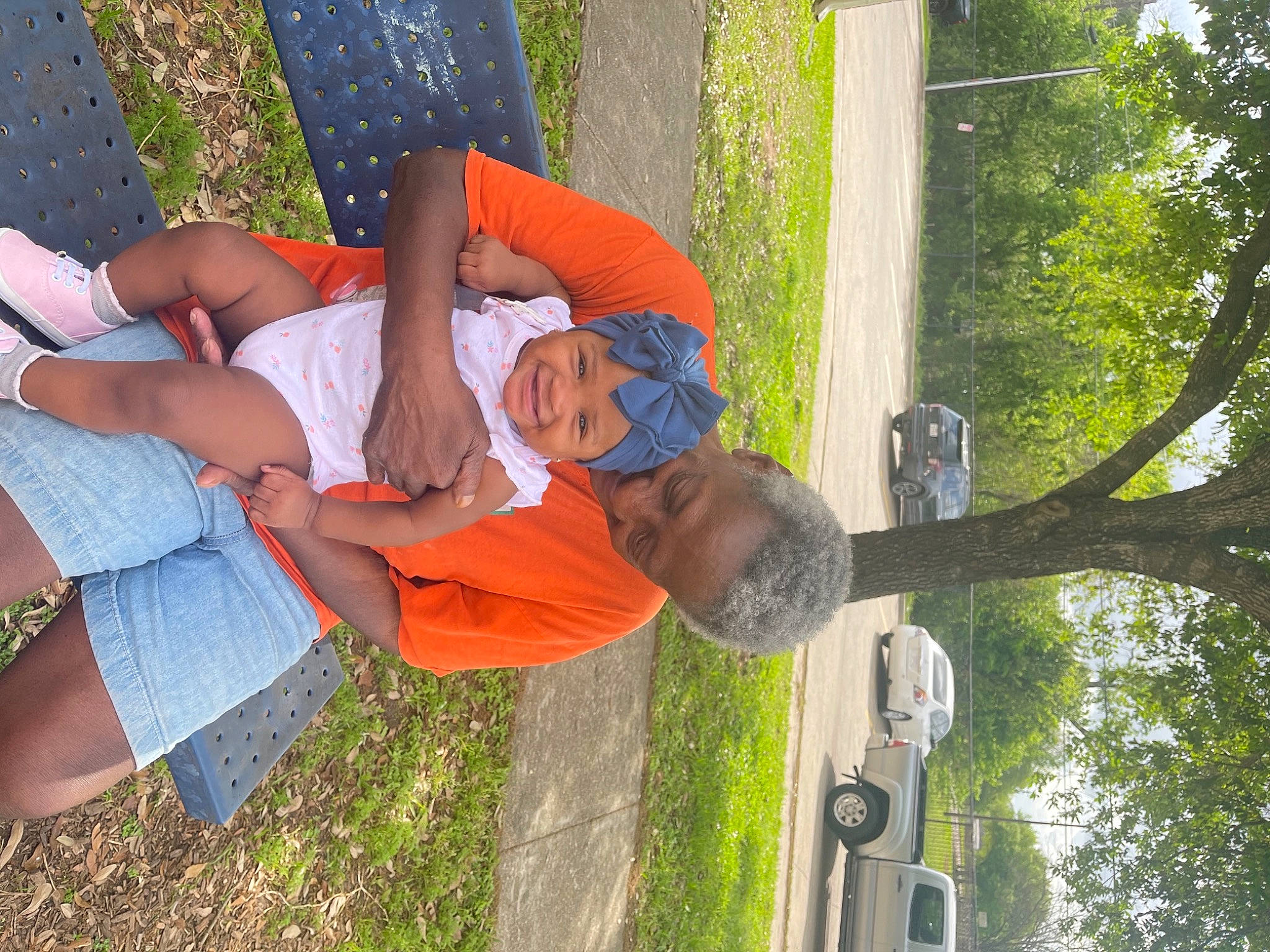 Mahalia is registered to the contest to win money with this photo: automotive_exterior, car, elbow, fun, grass, green, happy, hat, headwear, human_leg, joy, leaf, leisure, person, plant, recreation, shorts, t_shirt, thigh, tree