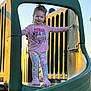 casual_clothing, child, curly_hair, cute, daytime, footwear, fun, girl, happy, legs, outdoor, park, person, pink_shirt, play, playground, slide, smiling, structure, sunlight