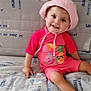 Mia participe au concours pour gagner de l'argent avec cette photo : baby, baby_toy, child, cozy, cute, face, happy, indoor, infant, nautical_theme, pink_hat, pink_outfit, playful, portrait, quilt, sitting, smiling, toddler, toy, young_child