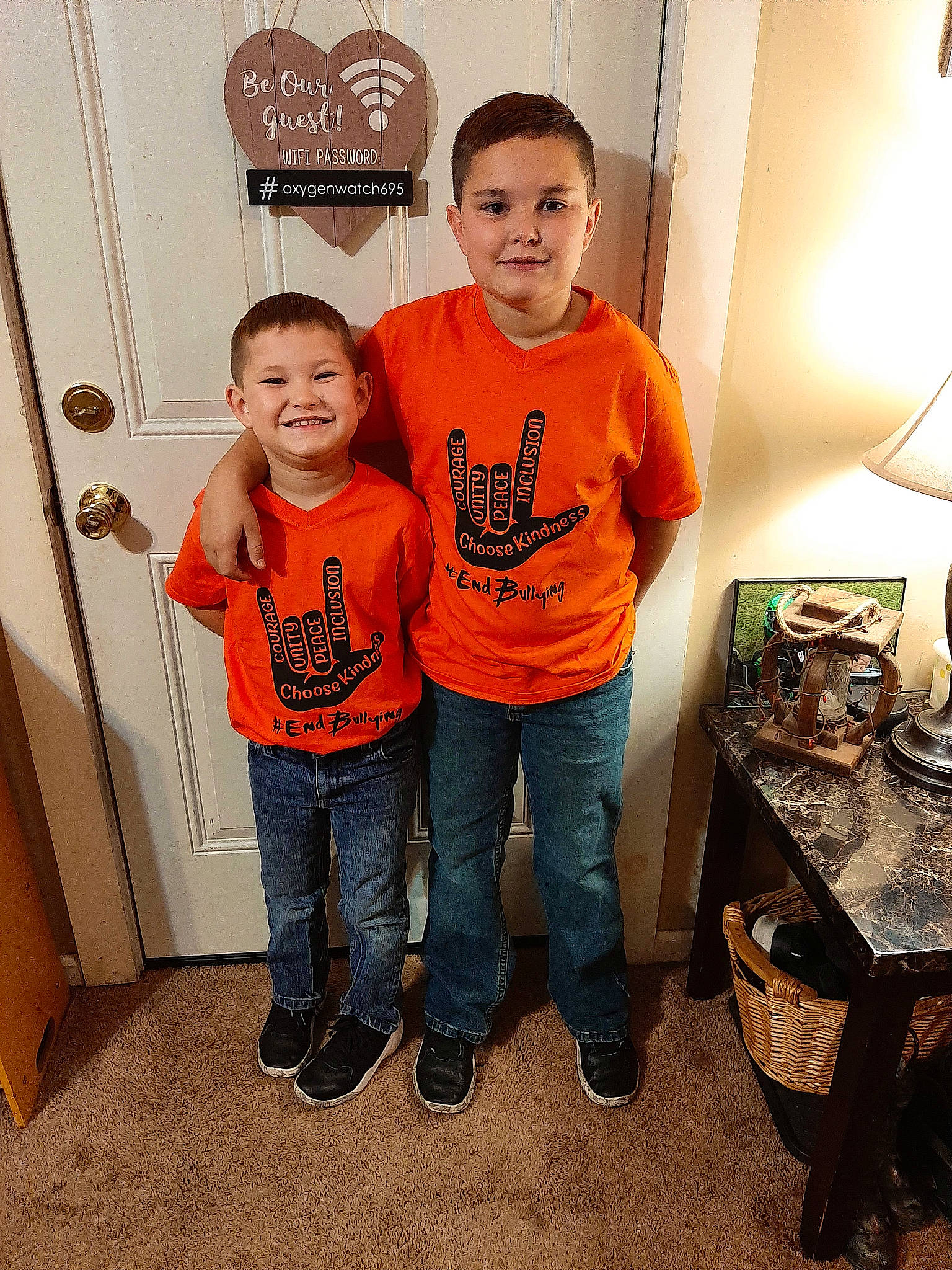 Easton And Hoyt is registered to the contest to win money with this photo: child, denim, door, flooring, fun, gas, happy, jeans, joy, lamp, light_fixture, logo, person, room, sleeve, smile, t_shirt, table, toddler, top