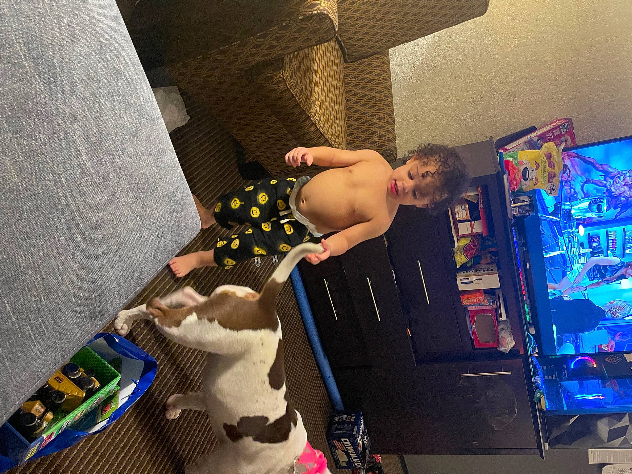 Xzavier is registered to the contest to win money with this photo: chest, child, flooring, fun, games, human_leg, indoor_games_and_sports, leisure, machine, person, play, recreation, recreation_room, room, selfie, swimwear, television_set, thigh, toddler, toy