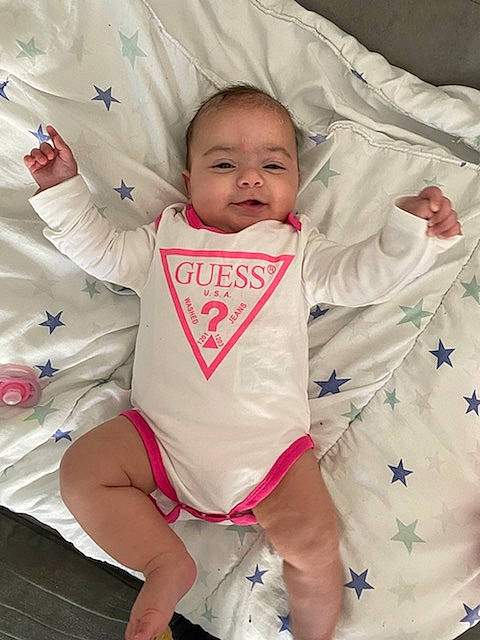 Liya participe au concours pour gagner de l'argent avec cette photo : baby, baby_safety, baby_toddler_clothing, cheek, comfort, eye, hand, happy, head, human_body, leg, linens, mouth, person, pink, skin, sleeve, smile, textile, toddler