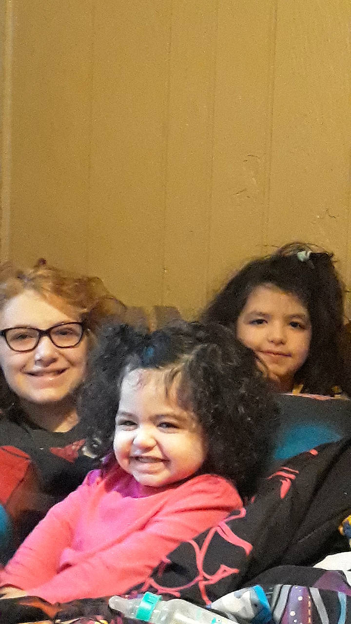 Lacey is registered to the contest to win money with this photo: cheek, child, event, eyewear, face, fun, gesture, hair, hairstyle, happy, head, iris, joy, leisure, outerwear, person, room, sharing, sitting, skin