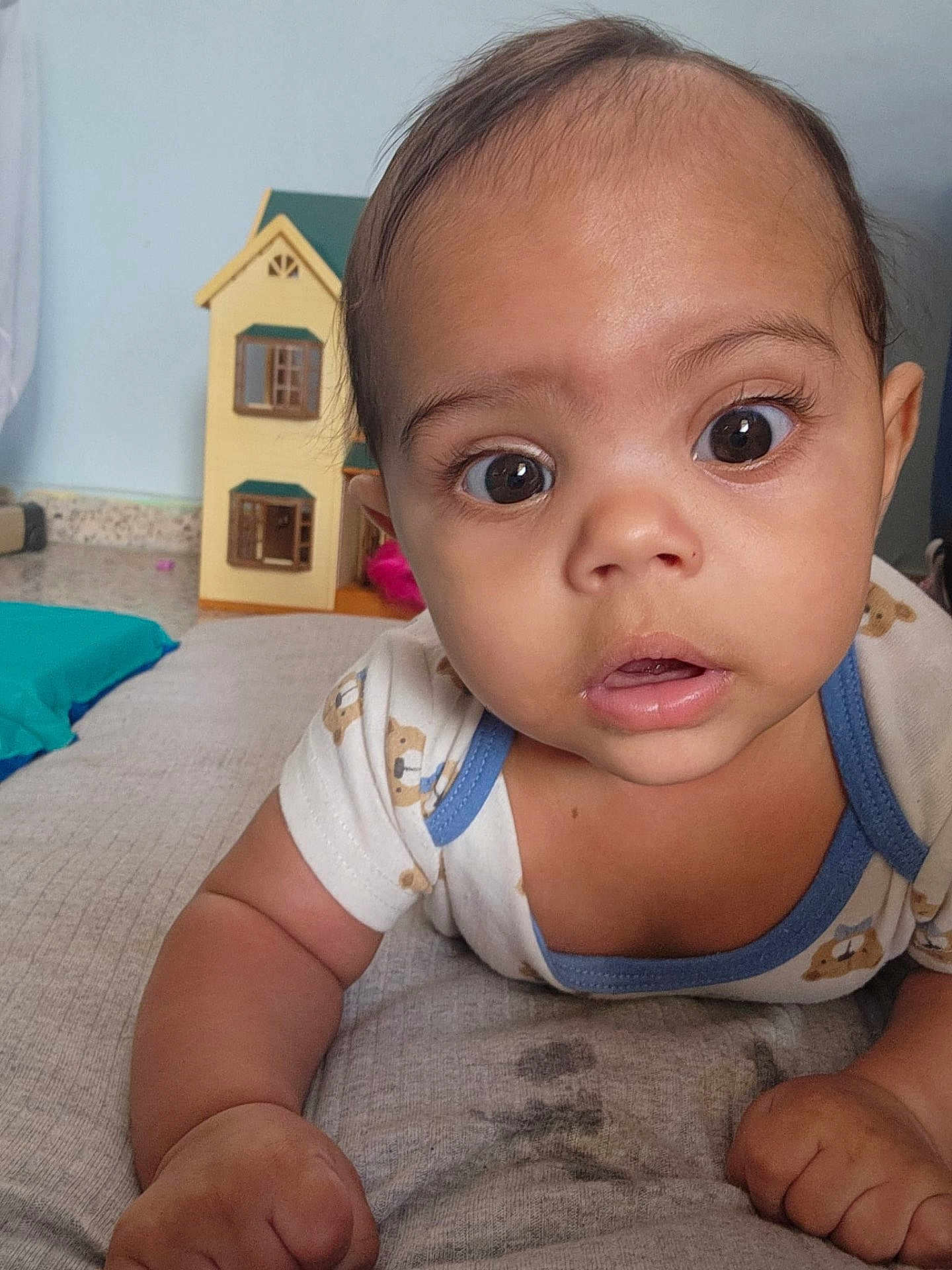 Matheo Isaias is registered to the contest to win money with this photo: baby, infant, face, eyes, portrait, closeup, onesie, toddler, hands, indoor, toy_house, mattress, curious, gaze, cute, skin, cheeks, nose, expression, photography