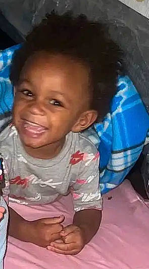 Leonard is registered to the contest to win money with this photo: baby, baby_toddler_clothing, black_hair, cheek, child, chin, eyebrow, forehead, fun, hairstyle, happy, iris, joy, lip, mouth, nose, person, sitting, skin, smile