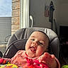 Michaëla participe au concours pour gagner de l'argent avec cette photo : baby, child, high_chair, toy, pink_toy, indoor, window, natural_light, happy, smiling, face, hand, clothing, seat, colorful, playful, infant, cheerful, person, candid