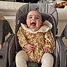 baby, smiling, baby_seat, floral_dress, lace_collar, white_tights, happy, infant, indoor, living_room, sofa, furniture, person, child, cute, seatbelt, cozy, home, portrait, comfortable