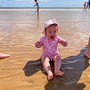 Aurora is registered to the contest to win money with this photo: baby, child, beach, sand, water, ocean, swimsuit, hat, splashing, sunny, sky, clouds, play, happy, smiling, summer, vacation, people, shore, foot