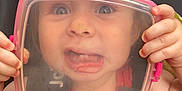 Aurora is registered to the contest to win money with this photo: toddler, child, face, plastic_container, car_seat, red_shirt, hands, funny_expression, wide_eyes, tongue_out, hair_tie, pink, colorful, seatbelt, closeup, indoors, playful, cute, person, baby