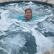 Baylynn joined the competition — help win amazing prizes! child, hot_tub, water, foam, bubbles, floaties, swimming, backyard, garden, chairs, greenery, outdoor, playful, summer, fun, happy, splashing, pool, recreation, person