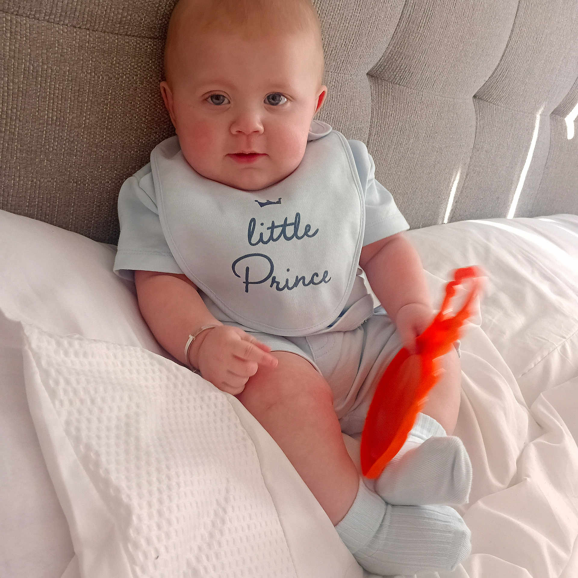 Patrick Thomas is registered to the contest to win money with this photo: baby, bib, bodypart, clothing, couch, cushion, face, finger, furniture, hand, head, homedecor, hosiery, newborn, person, photography, portrait, sitting, sock, toy