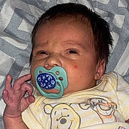 Nolan joined the competition — help win amazing prizes! baby, newborn, pacifier, onesie, winnie_the_pooh, hand_gesture, blanket, sleepwear, cute, infant, face, expression, lying_down, patterned_blanket, child, soft_lighting, indoors, portrait, person, resting