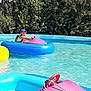 Yanis participe au concours pour gagner de l'argent avec cette photo : activity, blue_cap, boy, bumper_boat, child, colorful, floating, fun, greenery, leisure, life_vest, outdoor, play, pool, recreation, steering_wheel, summer, sunny_day, trees, water