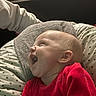 Kathalëya participe au concours pour gagner de l'argent avec cette photo : baby, cheerful, closeup, cozy, cushion, face, hand, happy, head, indoors, infant, laughing, person, portrait, red_clothing, skin, smiling, star_pattern, towel, white_sleeve