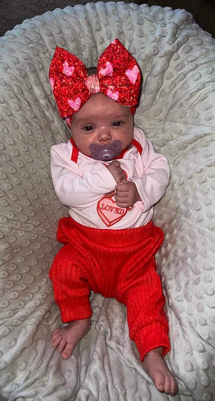 Emersyn is registered to the contest to win money with this photo: baby, baby_toddler_clothing, cap, carmine, child, comfort, costume_hat, eye, face, fun, happy, head, headgear, headwear, human_body, pattern, person, pink, red, skin