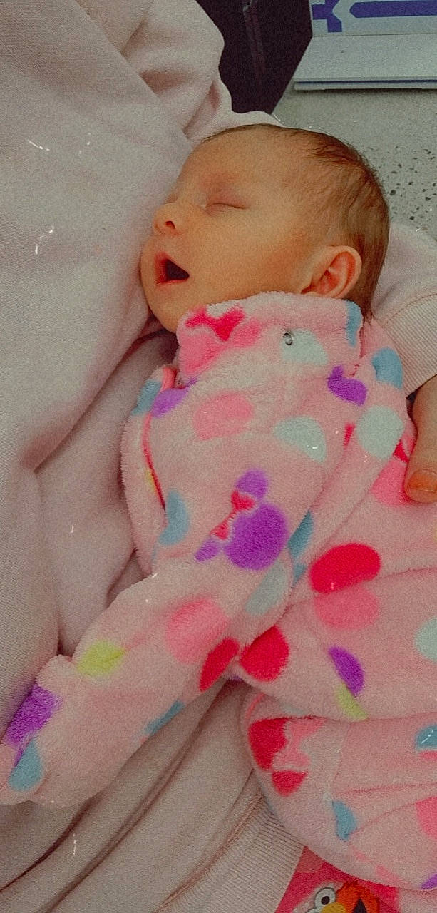 Jamie is registered to the contest to win money with this photo: baby, baby_sleeping, baby_toddler_clothing, cheek, child, comfort, eye, finger, hand, happy, head, human_body, lip, nail, person, pink, skin, sleeve, textile, thumb