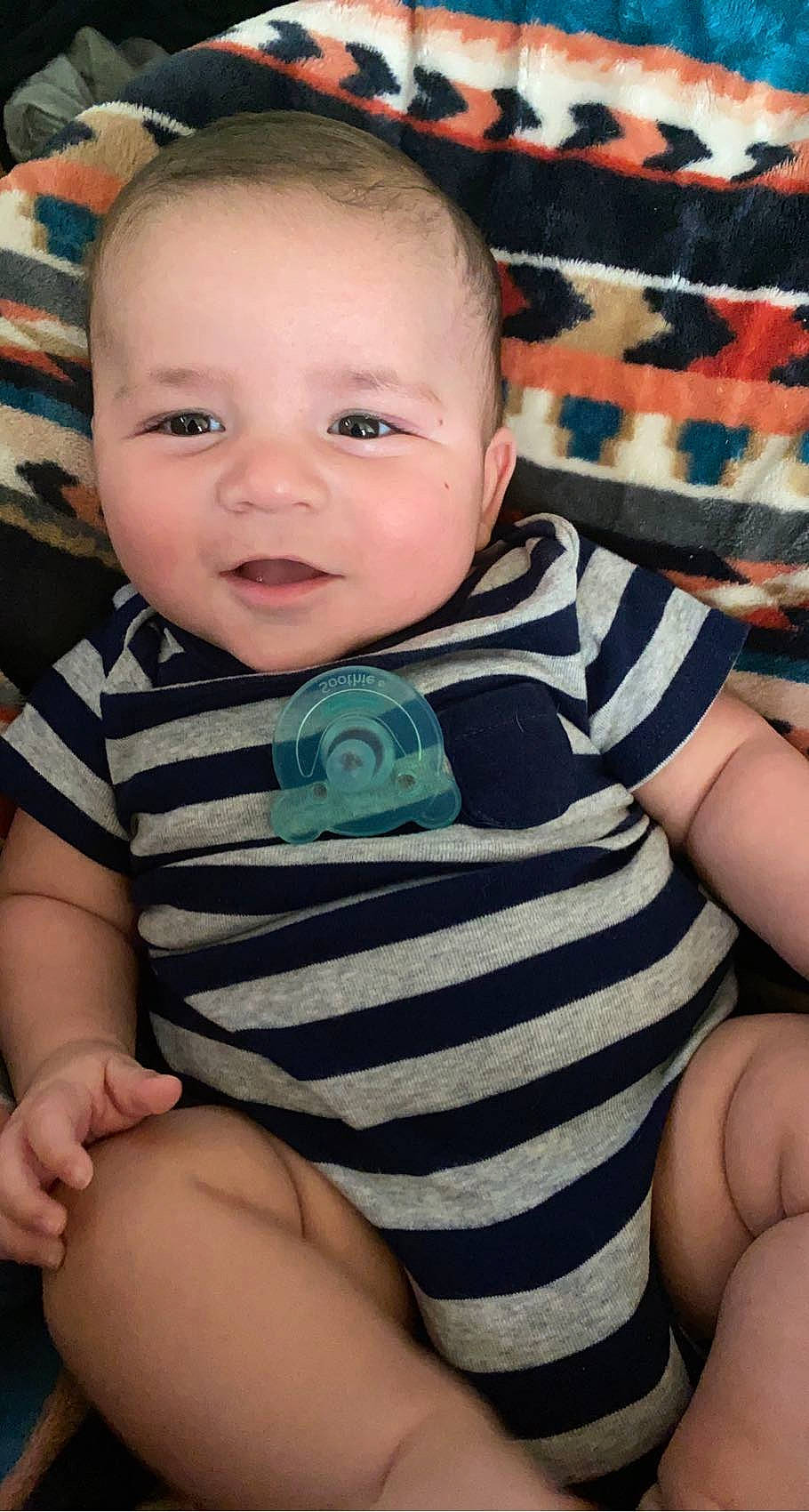 Lachlan is registered to the contest to win money with this photo: arm, baby_toddler_clothing, cheek, chin, comfort, eye, facial_expression, hairstyle, hand, head, mouth, nose, organ, person, product, skin, sleeve, smile, standing, textile