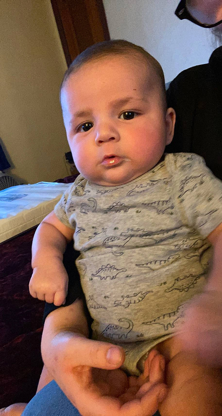 Lachlan is registered to the contest to win money with this photo: baby_toddler_clothing, cheek, comfort, dress, eye, face, finger, forehead, gesture, hand, head, human_body, iris, lip, mouth, neck, nose, person, skin, sleeve